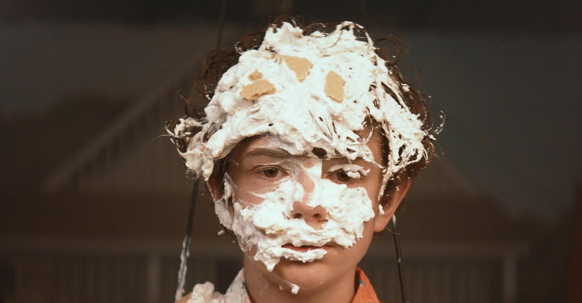 Image of a boy with shaving cream all over his face