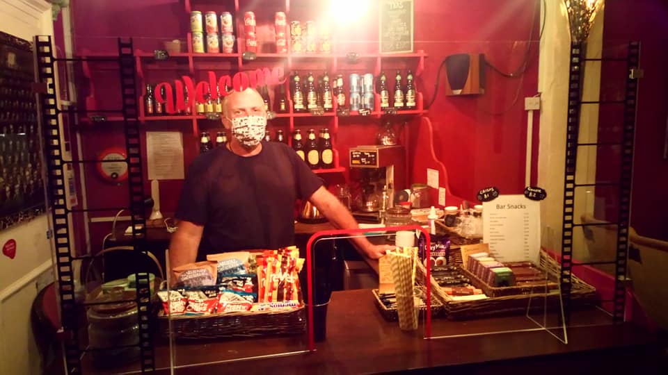 Alan in mask behind perspex screen