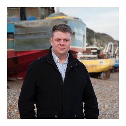 Jake Bowers, standing by the fishermans huts