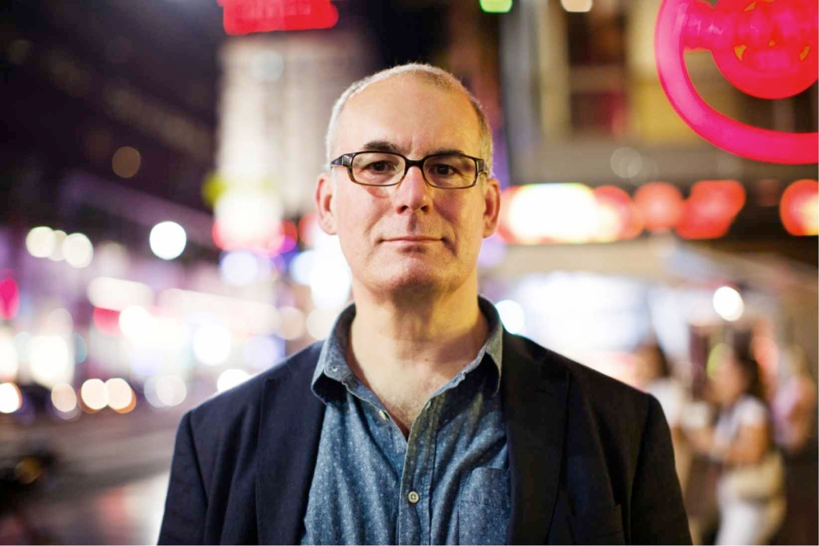 David Quantick, standing in nighttime city scene.