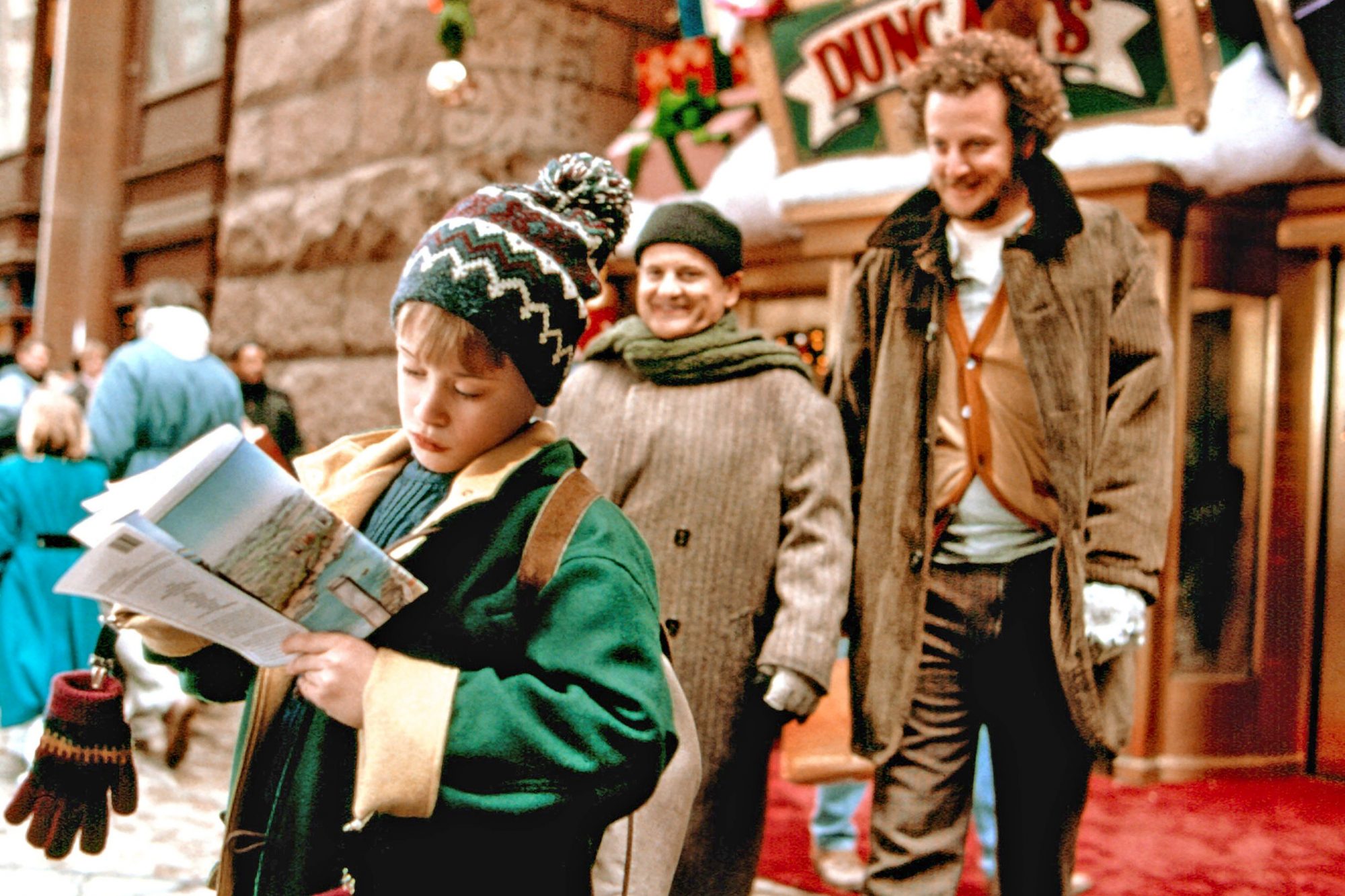 Boy in christmas clothing with two men behind him looking like they are going to pounce on him Boy in christmas clothing with two men behind him looking like they are going to pounce on him