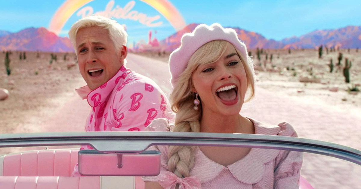 Man and woman in pink clothing driving a car in bright road