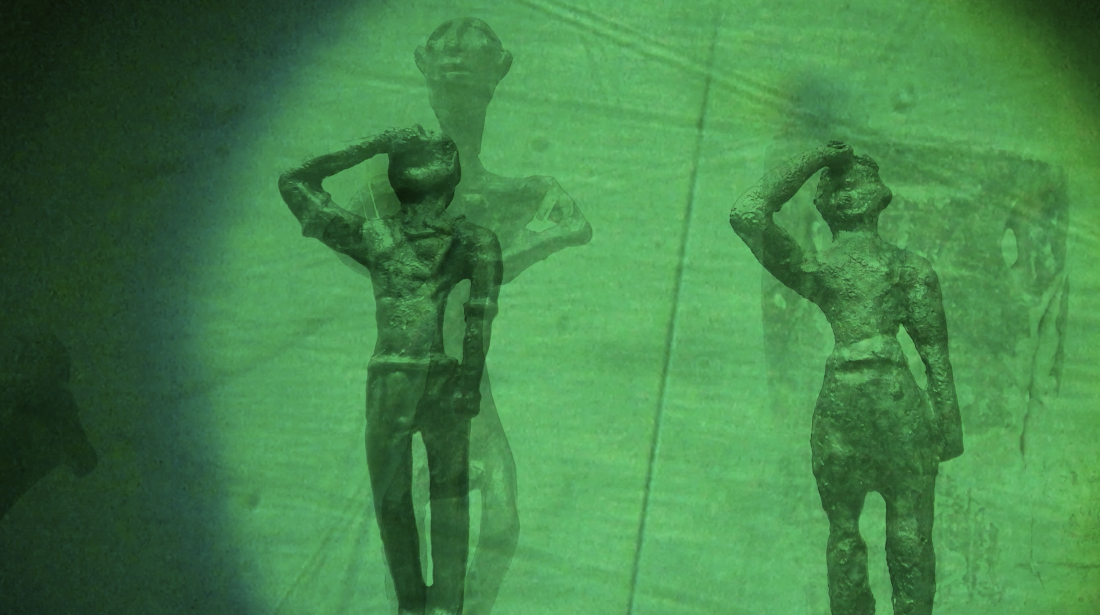 Two Minoan statues in a green haze
