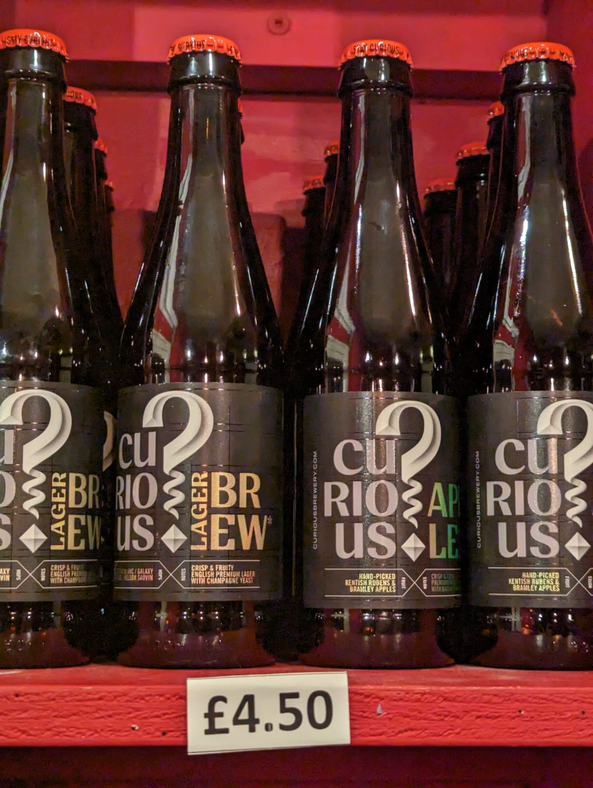 Collection of Curious Brew drinks on display on shelves