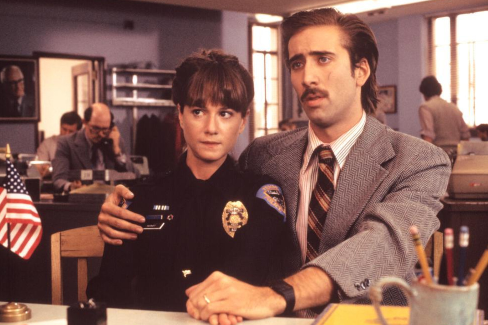 Holly Hunter and Nicolas Cage in 80s clothing