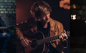 Jason McNiff holding a guitar