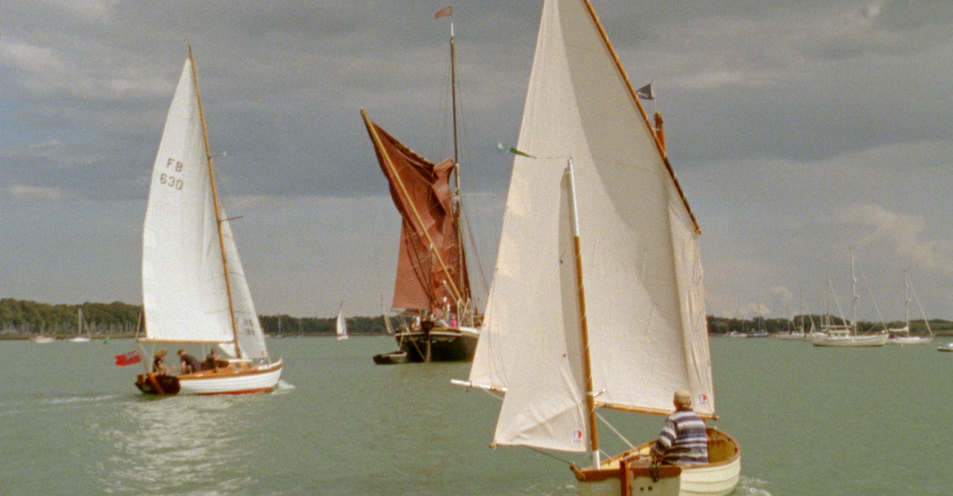 People sitting in sailing boats out at sea